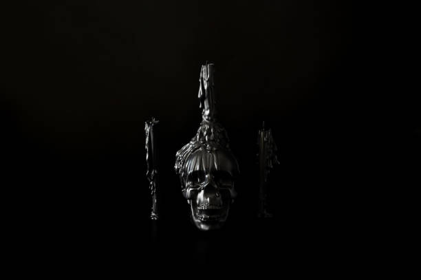 Halloween background with skull that have candle on it with another candles on black background. Minimal concept.