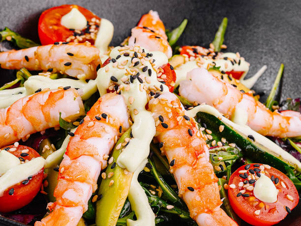istock Delicious salad with shrimps, avocado and cherry tomatoes covered with seed dressing 2177188517