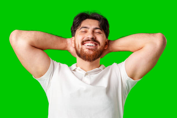 istock A man with a beard smiles confidently against a bright green background 2177188570