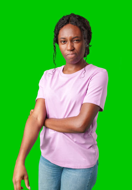 istock Young woman with curly hair shows a skeptical expression against a bright green background 2177189568