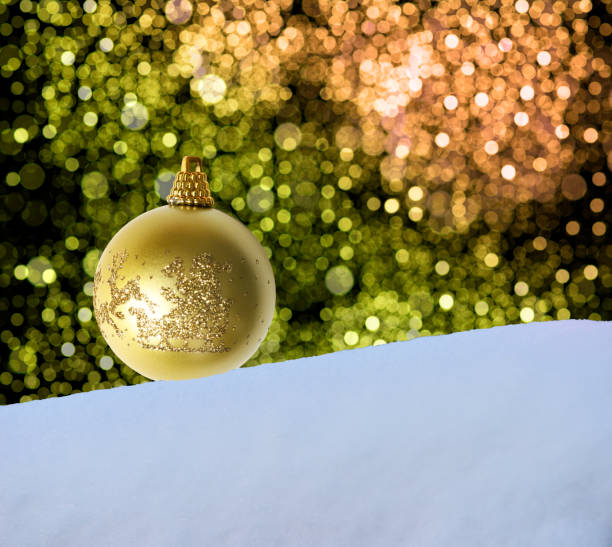Close-up of Christmas ornaments on the snow against defocused illumination with copy space.