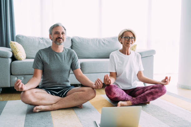 istock Couple meditating in Lotus position at home. 2177190133