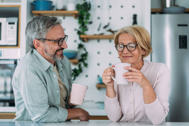 istock Lovely couple drinking coffee at home. 2177190136