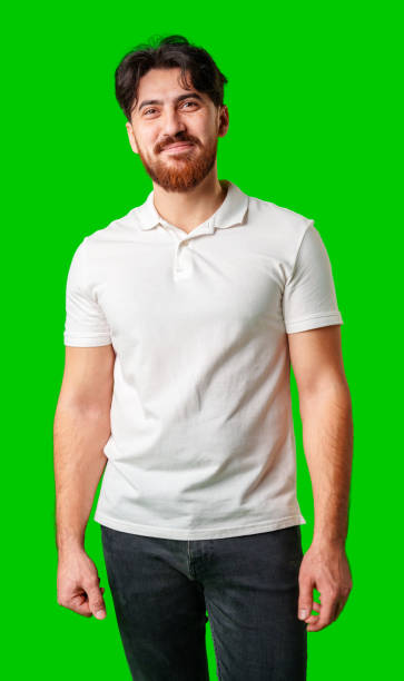 istock Young man with a beard smiling while standing against a bright green background 2177190394