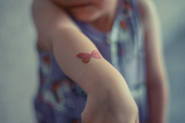istock A young girl has a butterfly tattoo on her arm 2177190755