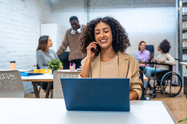 istock Cheerful woman talking to the mobile while working at coworking 2177190907