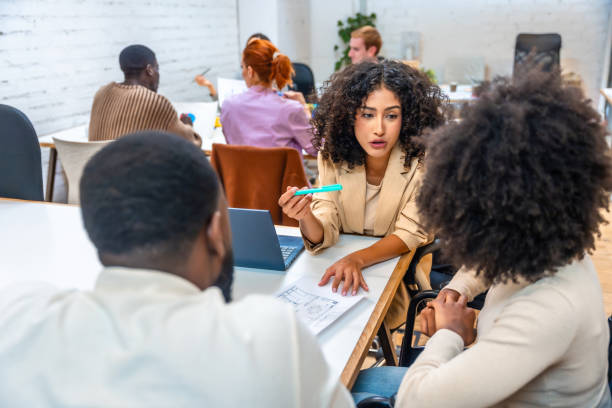 Coworkers discussing data in a coworking meeting room