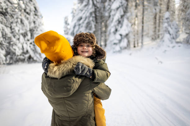 A mother and her son enjoy a beautiful winter day outdoors.