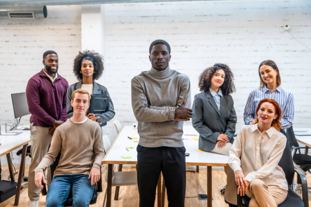istock African man standing next colleagues sitting around a coworking table 2177191297