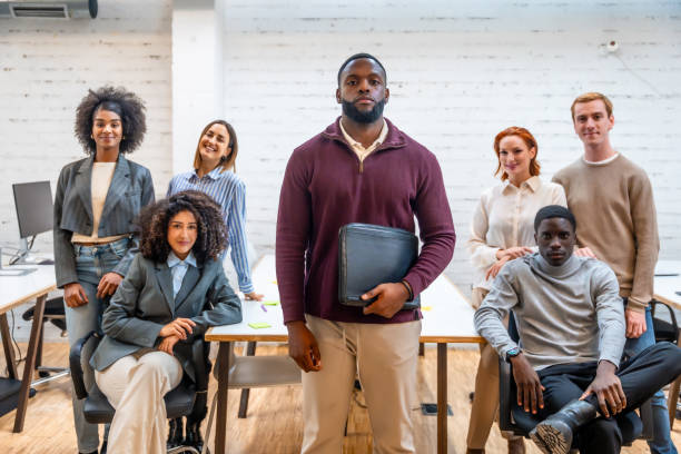 istock African man standing in a coworking surrounded by colleagues 2177191321