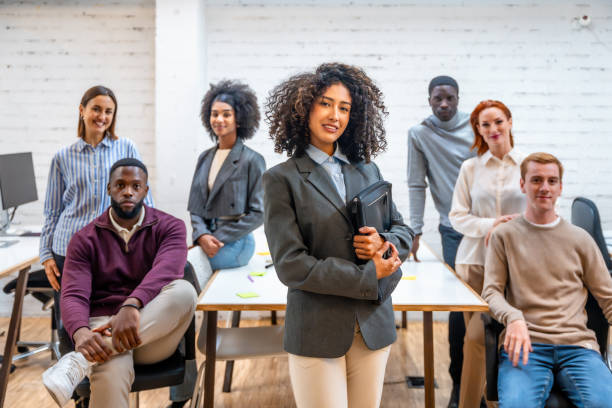 istock Female leader standing next to teamwork in a coworking 2177191322