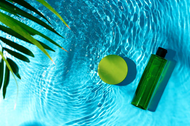 istock Green bottle floating on a clear blue swimming pool during bright daylight 2177192164