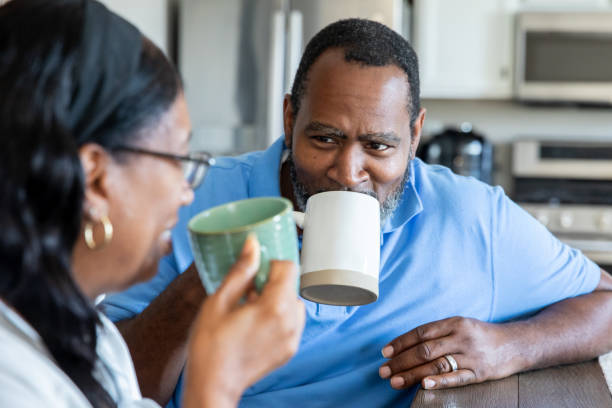 istock Senior couple have morning coffee together while sitting at kitchen table 2177193583