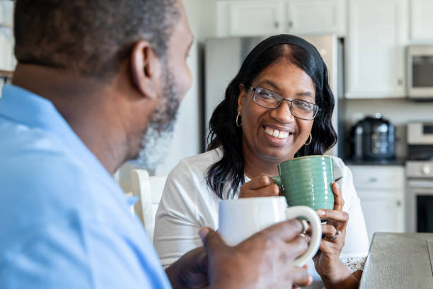 istock Senior couple have morning coffee together while sitting at kitchen table 2177193647