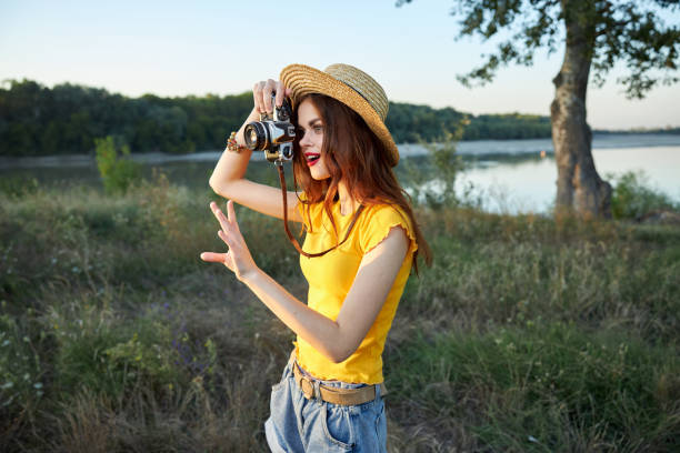 An Asian famale photographer is working in autumn