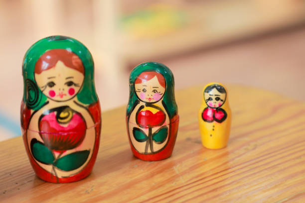 istock Three small wooden Russian nesting dolls on a wooden surface 2177194445