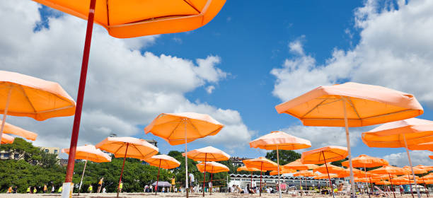 Orange beach umbrellas against blue sky
