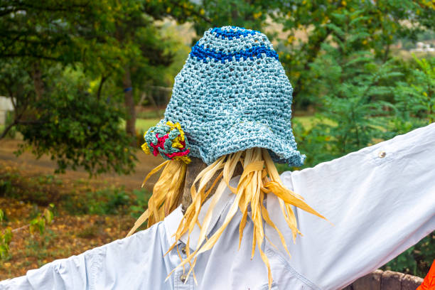 Autumn portrait of 2-3 years old child in garden. Fall season. Close-up view of cheerful sweet mixed-race baby boy in knitted cap
