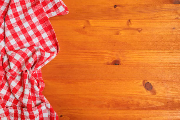 istock Top view of wooden kitchen table with checkered red and white table cloth 2177196633