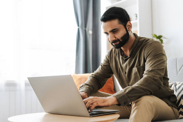 istock Focused middle aged indian freelancer working from home on laptop, copywriter typing on keyboard 2177197100