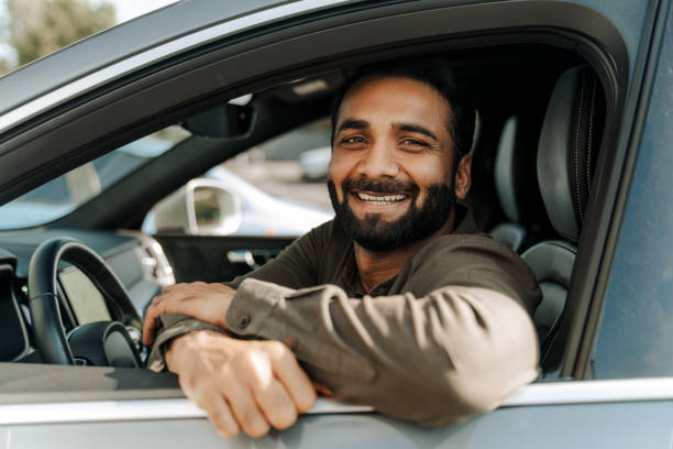istock Happy Idian man smiling while sitting in car looking at camera 2177197123