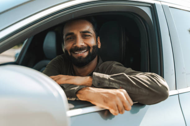 istock Happy driver, Indian man smiling while sitting inside his new car 2177197126