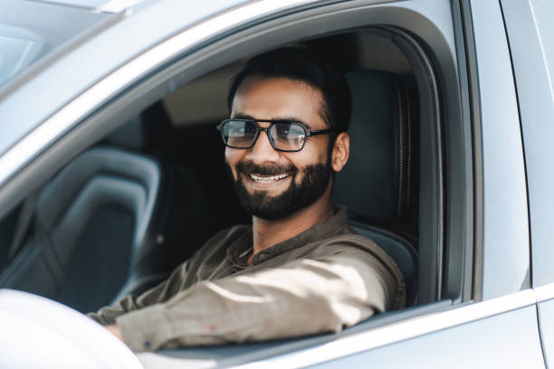 istock Happy indian man smiling while driving a car 2177197134