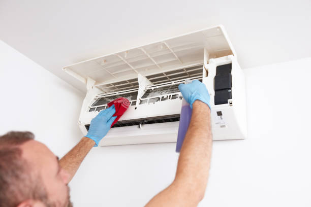 istock Man cleaning and maintaining air condition unit at home. 2177197970