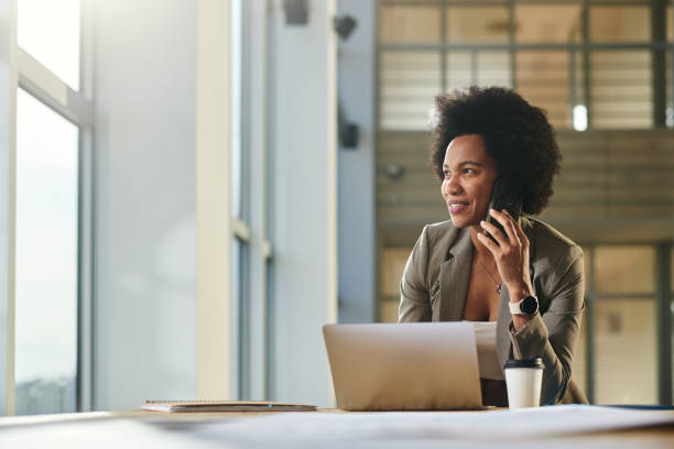 istock Black female architect on the phone working on laptop in the building. 2177198968