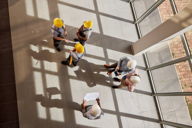 istock Above view of multi-tasking construction team working in the building. 2177199190