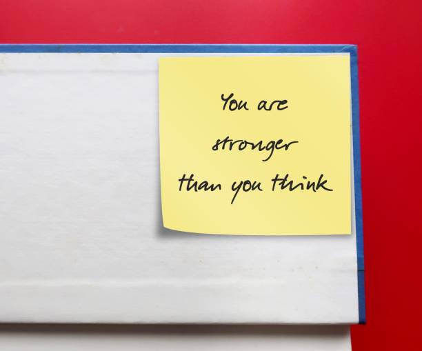 istock Stick note on a book with message written YOU ARE STRONGER THAN YOU THINK - self talk to boost self-confidence. Positive affirmation to remind you have power to break free from self-doubt 2177199473