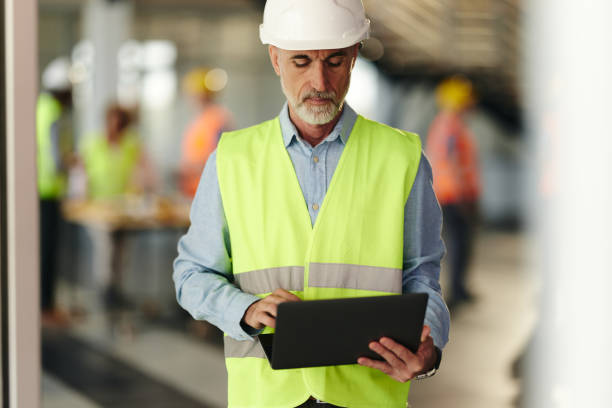 istock Senior building contractor working on laptop in the office. 2177199568