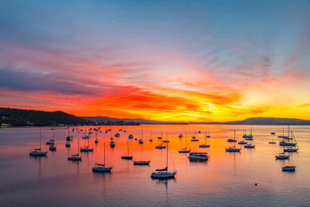 istock Aerial sunrise waterscape with boats and high cloud 2177204612