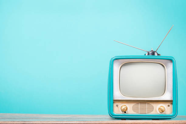 istock Retro CRT TV with antenna on old table front gradient mint blue background. Vintage style filtered photo 2177205420