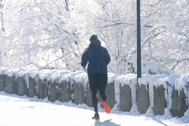 istock The man is jogging in the winter park. 2177205725
