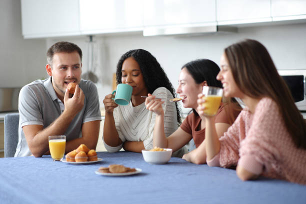 istock Four interracial friends having breakfast in the kitchen 2177206278