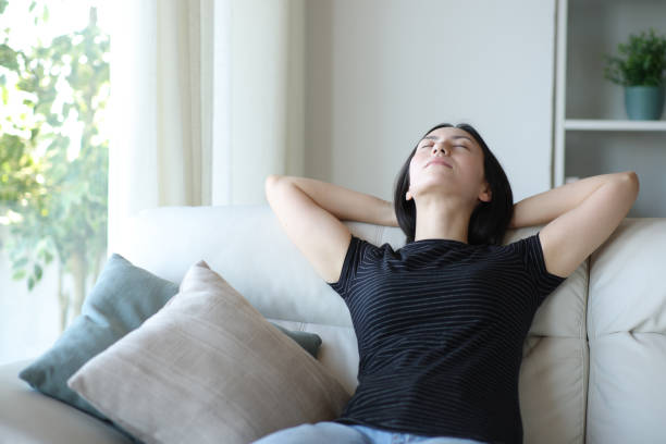 istock Relaxed asian woman resting on a couch at home 2177206618