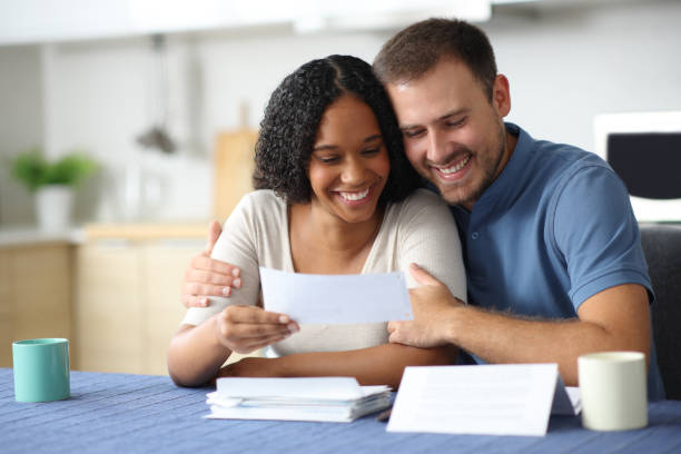 istock Happy interracial couple checking receipt at home 2177206724