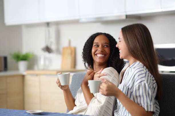 istock Happy interracial lesbian couple drinking and looking with love 2177206820