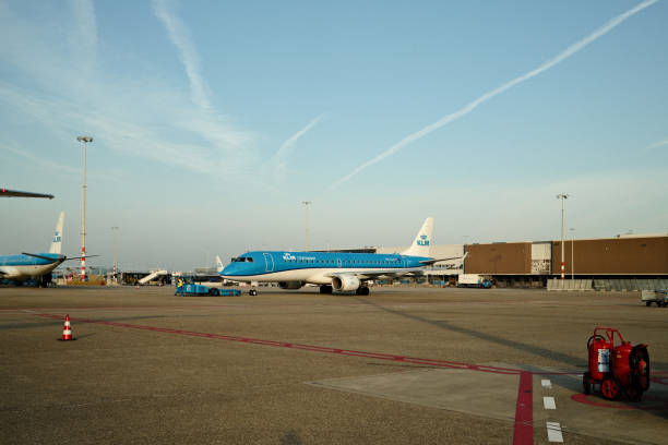 Amsterdam Schiphol Airport, Netherlands – 09/02/2024: Klm embraer 190 aircraft is being prepared for takeoff by ground crew at an airport gate