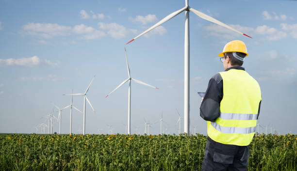 istock Engineer with tablet computer on a background of wind turbine. 2177207079