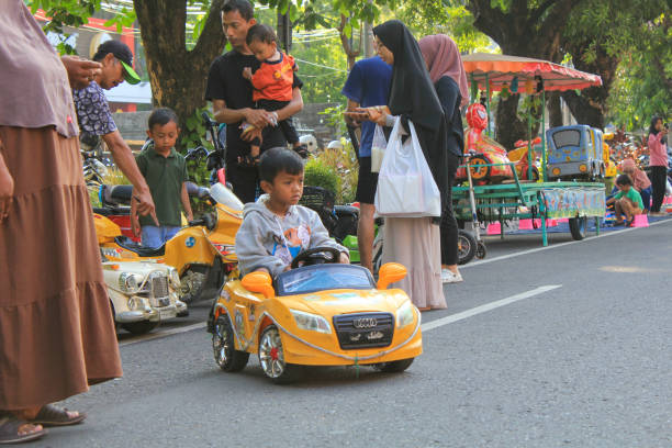 indonesia,solo - September 29,2024 : little boy driving remote control car on the road