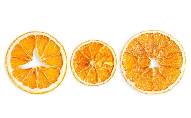 istock Elevated view of three dried natural scented orange citrus fruit slices isolated on white 2177218954