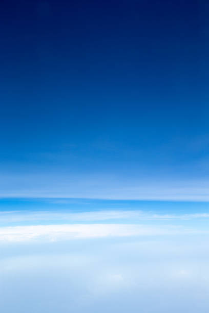 white fluffy clouds with rainbow in the blue sky