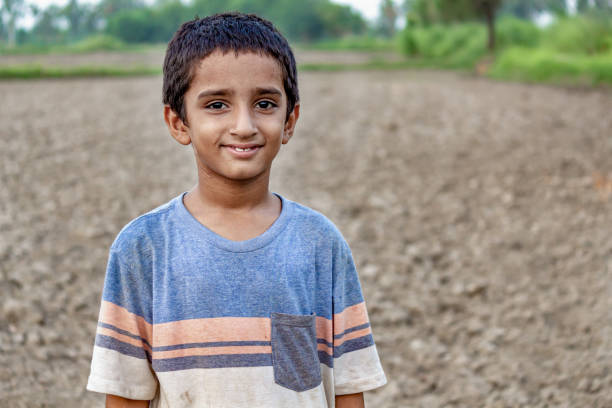 a Smiling Indian Boy in a Rural Landscape