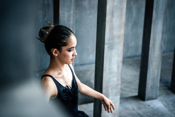 Cute little girl dreaming of becoming a ballerina. Child girl in a red tutu dancing on the stage.