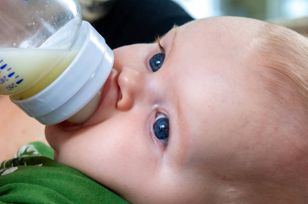 Close-up of Baby boy drinking milk from milk bottle.