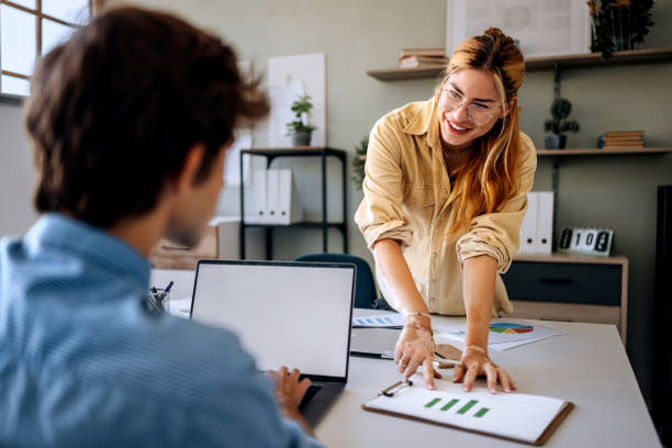 istock Two young casually clothed colleagues discussing work at modern office 2177223755