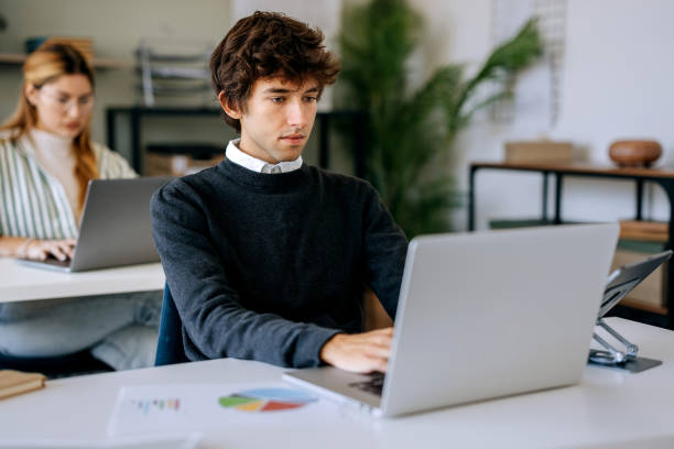 istock Young casually clothed man working at office 2177224125