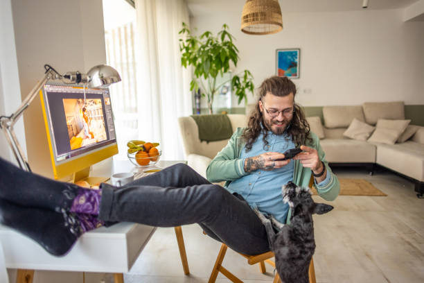 istock Man working from home and playing with his dog 2177224812